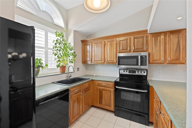 kitchen with backsplash, sink, black appliances, lofted ceiling, and light tile patterned flooring