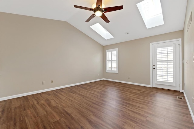 empty room with lofted ceiling with skylight, ceiling fan, and wood-type flooring