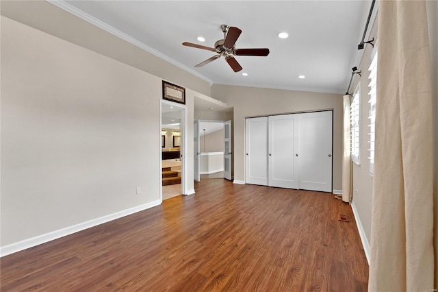 unfurnished bedroom featuring ensuite bath, ornamental molding, vaulted ceiling, ceiling fan, and hardwood / wood-style floors