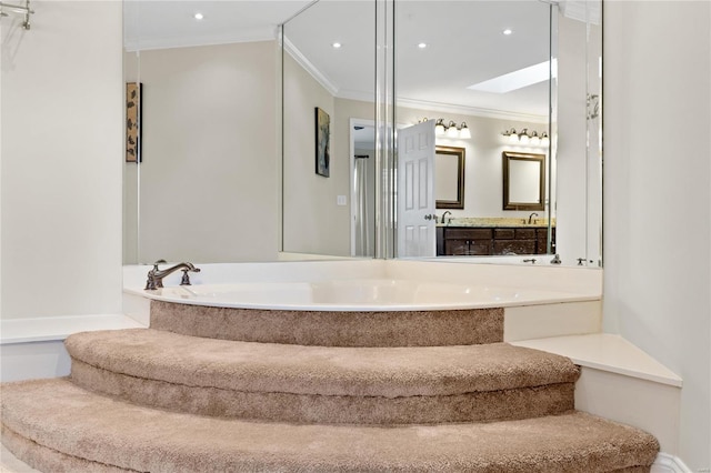 bathroom featuring vanity, ornamental molding, a tub, and a skylight