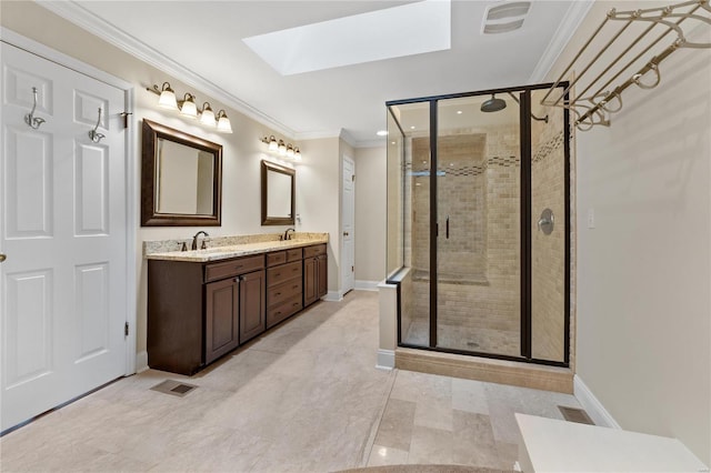 bathroom with vanity, a skylight, a shower with door, and ornamental molding