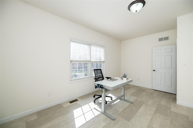 unfurnished office featuring visible vents and baseboards