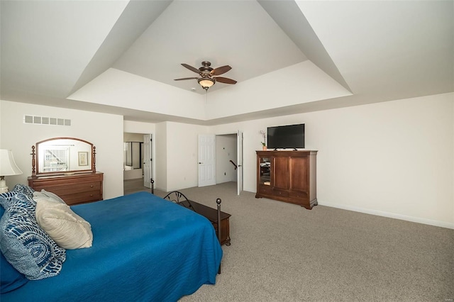 bedroom featuring visible vents, baseboards, carpet floors, ceiling fan, and a raised ceiling