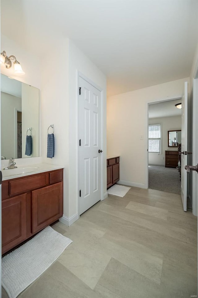 bathroom with vanity and baseboards