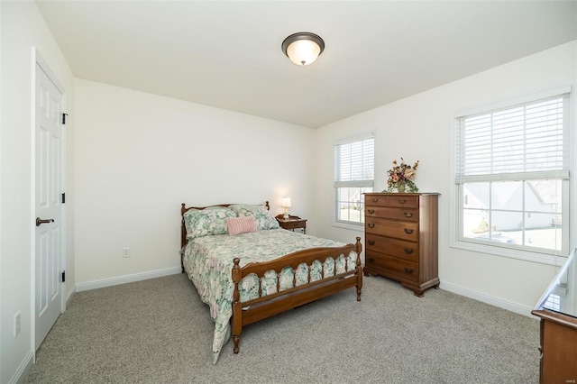 carpeted bedroom featuring baseboards