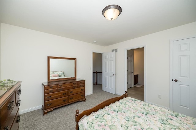 carpeted bedroom featuring visible vents and baseboards