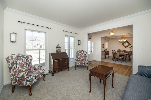 living area featuring crown molding and a notable chandelier