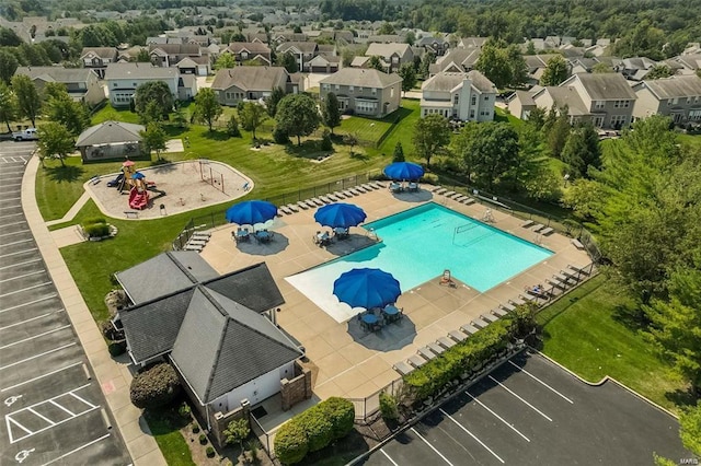 view of swimming pool with a residential view, a patio, and fence