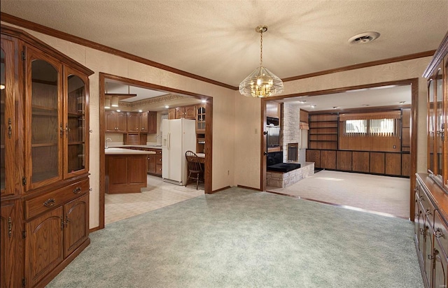 dining room featuring light colored carpet, a textured ceiling, and ornamental molding