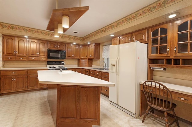 kitchen featuring a kitchen island with sink, black appliances, and sink