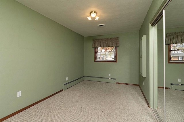 unfurnished room with a textured ceiling, light carpet, and plenty of natural light