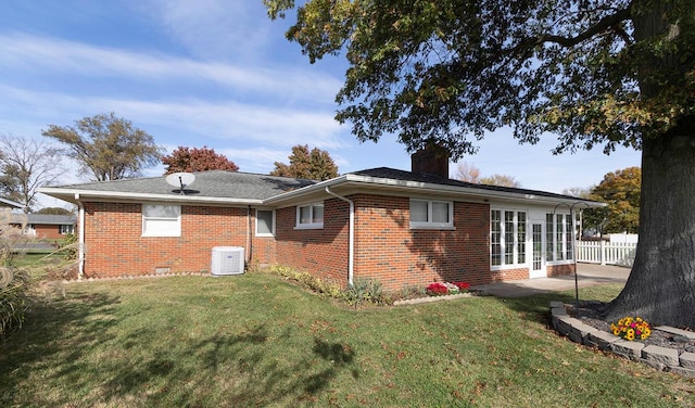 back of house featuring a patio, central air condition unit, and a yard