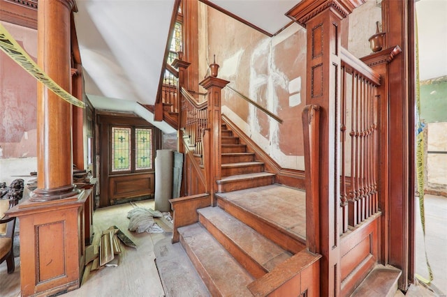 staircase featuring ornate columns