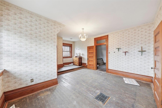 empty room featuring a chandelier and dark wood-type flooring