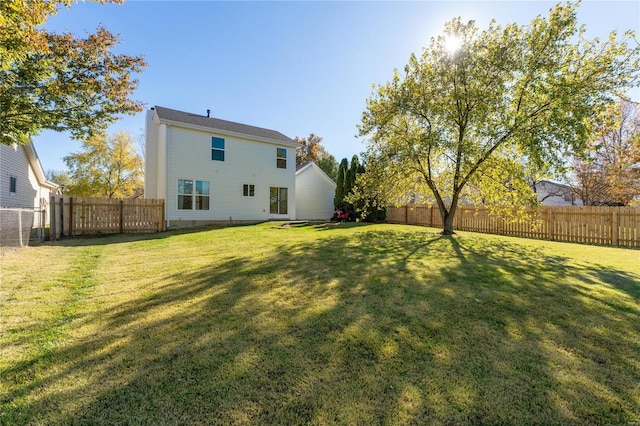 rear view of property with a yard