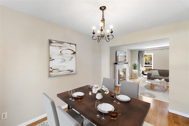 dining space with an inviting chandelier and hardwood / wood-style flooring