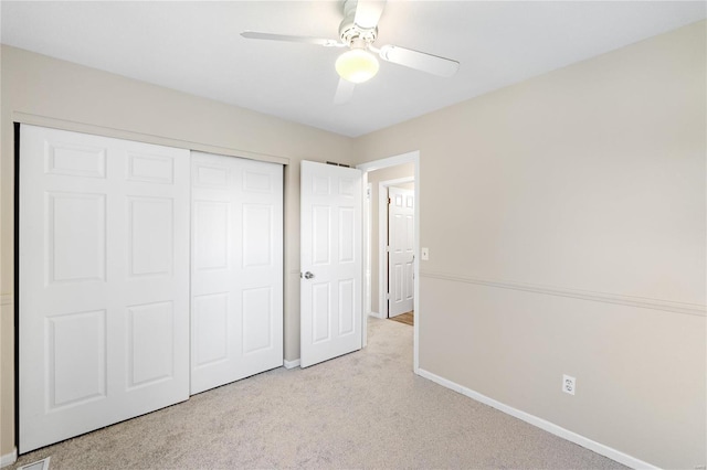 unfurnished bedroom with a closet, ceiling fan, and light colored carpet