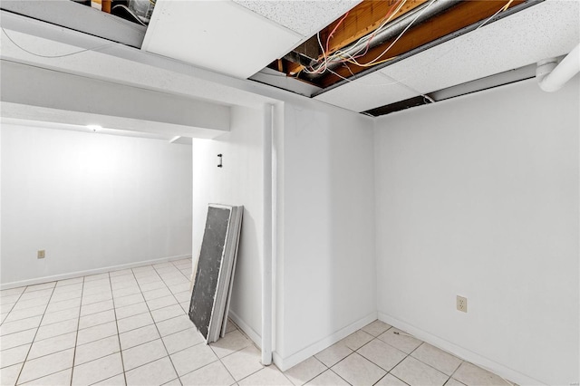 basement featuring light tile patterned floors