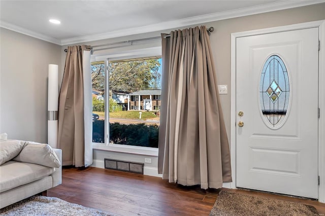 entryway with dark wood-type flooring and crown molding