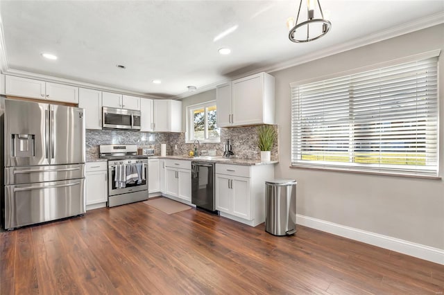 kitchen featuring stainless steel appliances, white cabinetry, ornamental molding, hanging light fixtures, and dark wood-type flooring