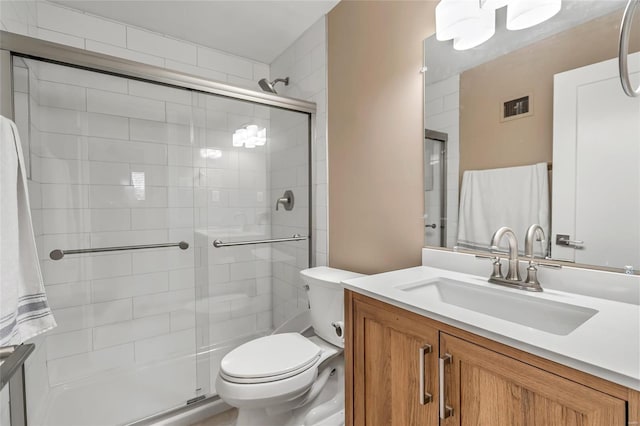 bathroom with walk in shower, vanity, and toilet