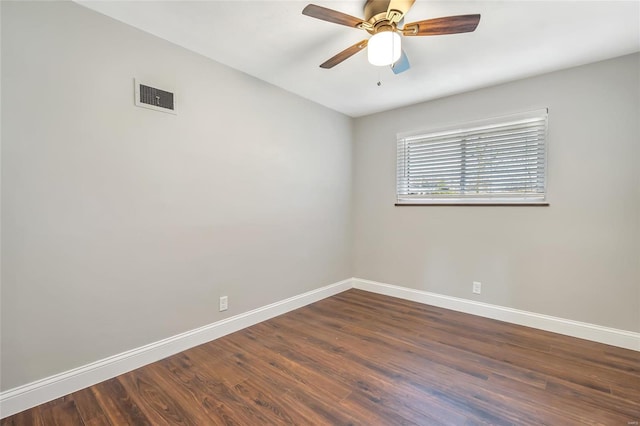 spare room featuring dark hardwood / wood-style floors and ceiling fan