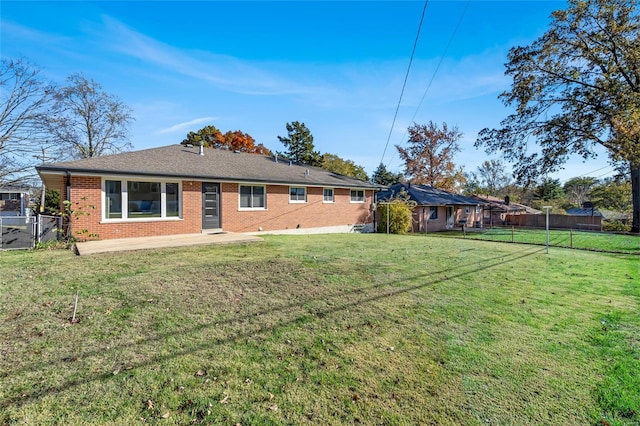 rear view of house featuring a lawn