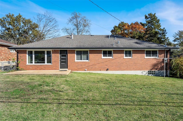 rear view of house featuring a patio and a lawn