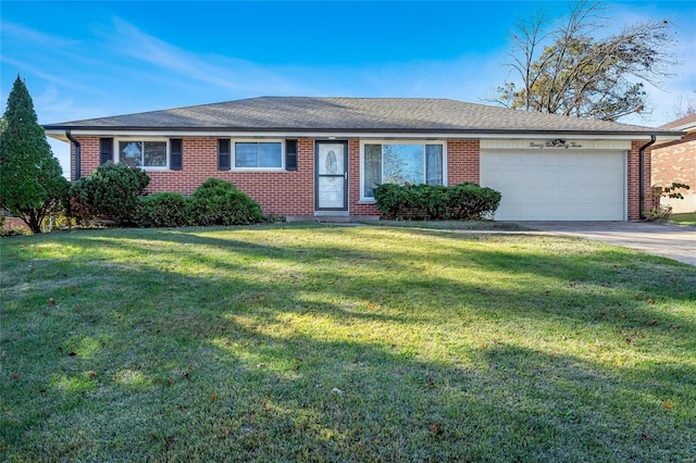 single story home featuring a garage and a front yard