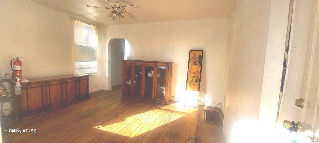 interior space featuring ceiling fan and dark hardwood / wood-style floors