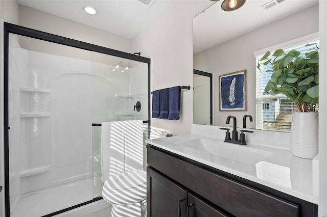 bathroom with vanity and a shower with door