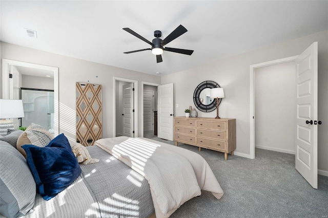 bedroom with ceiling fan, ensuite bath, and carpet flooring