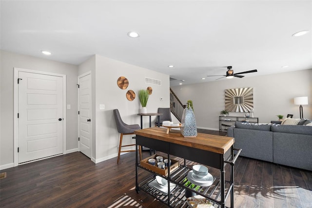 dining space featuring dark hardwood / wood-style flooring and ceiling fan