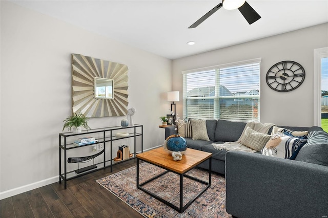 living room with ceiling fan and dark hardwood / wood-style flooring