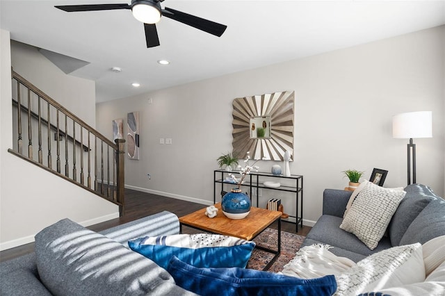 living room with dark hardwood / wood-style flooring and ceiling fan