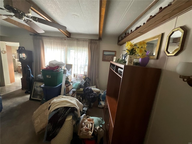 bedroom with concrete flooring, beamed ceiling, and ceiling fan