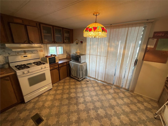 kitchen with white range with gas cooktop and hanging light fixtures