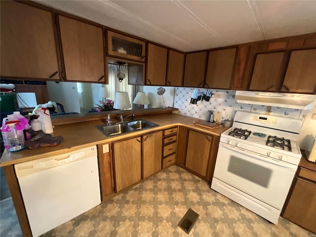 kitchen featuring range hood, white appliances, and sink