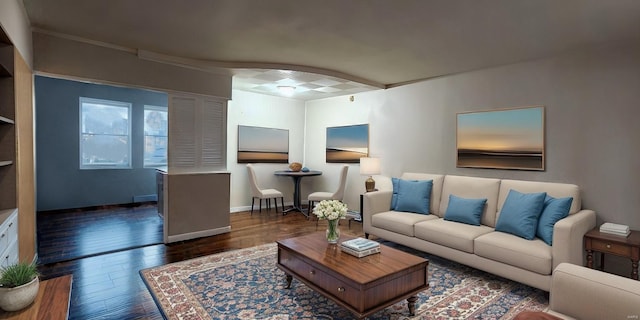 living room with dark wood-type flooring and crown molding