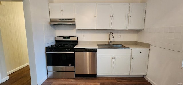 kitchen featuring white cabinetry, extractor fan, appliances with stainless steel finishes, tasteful backsplash, and dark hardwood / wood-style flooring