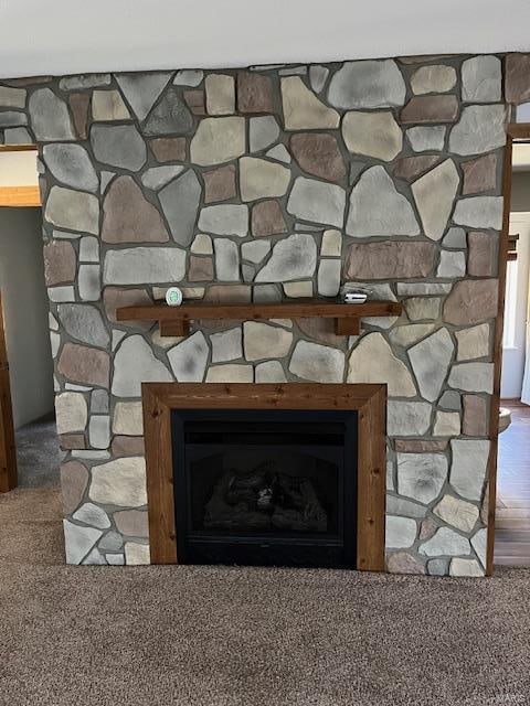 interior details featuring carpet flooring and a fireplace