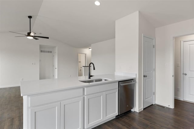 kitchen featuring stainless steel dishwasher, white cabinets, sink, and dark wood-type flooring