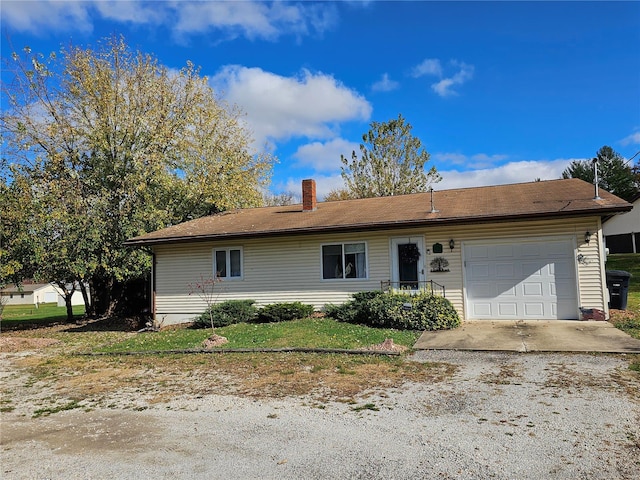 view of front of property featuring a front yard and a garage