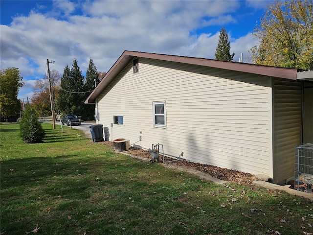 view of property exterior featuring a lawn and central AC