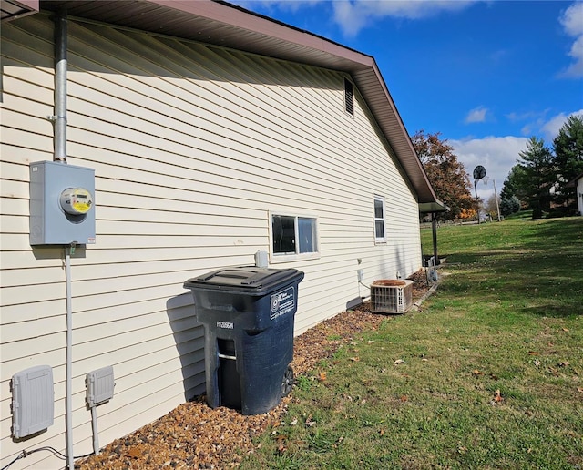 view of property exterior with a lawn and cooling unit