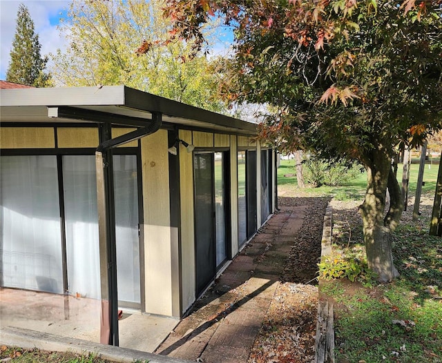 view of outdoor structure with a sunroom