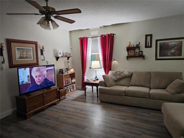 living room with a textured ceiling, ceiling fan, and dark wood-type flooring