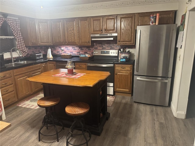 kitchen featuring wooden counters, backsplash, stainless steel appliances, dark wood-type flooring, and a kitchen island