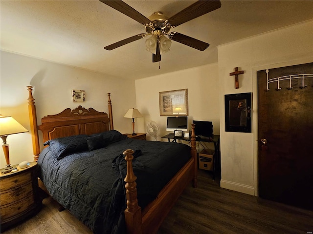 bedroom featuring dark hardwood / wood-style flooring and ceiling fan