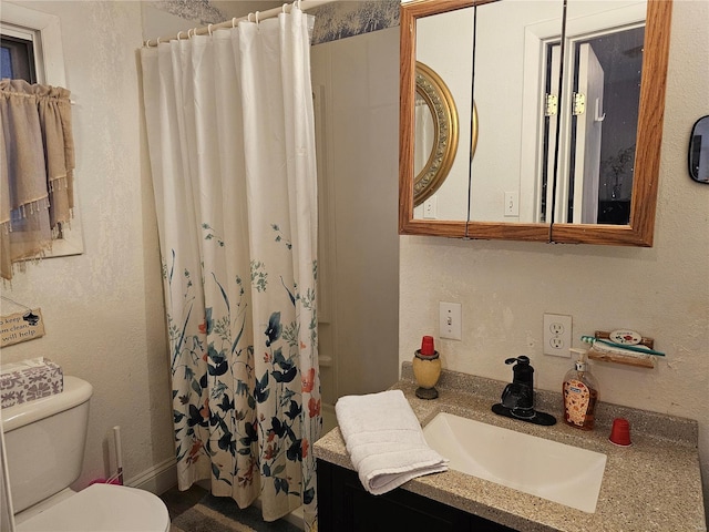 bathroom with vanity, toilet, and walk in shower